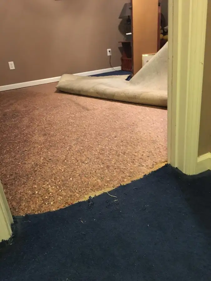 Carpet pad removal revealing water damage during Water Mitigation Services in Weatherford